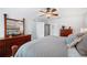 The primary bedroom features plush carpeting, ample storage in matching wooden furniture and a ceiling fan at 7016 Summit Cir, Winter Haven, FL 33884