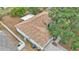 An aerial view of a home with a well-maintained roof and lush greenery surrounding the property at 7311 Briarbay Loop, Lakeland, FL 33810