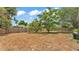 Spacious backyard featuring a wooden fence and mature trees at 7311 Briarbay Loop, Lakeland, FL 33810