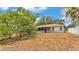 Well sized backyard with partial view of the screened patio and home at 7311 Briarbay Loop, Lakeland, FL 33810