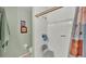 Bathroom featuring shower, tiled walls, grab bar, shower seat, and patterned shower curtain at 7311 Briarbay Loop, Lakeland, FL 33810