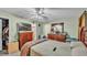 Bedroom featuring dresser with mounted TV, ceiling fan, and doorway at 7311 Briarbay Loop, Lakeland, FL 33810