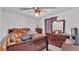 Bedroom featuring ceiling fan, dresser with mirror, and a wood frame bed at 7311 Briarbay Loop, Lakeland, FL 33810