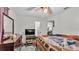 Bedroom featuring TV, ceiling fan, dresser and an open doorway at 7311 Briarbay Loop, Lakeland, FL 33810