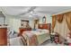 Bedroom with ceiling fan, dresser, and curtains at 7311 Briarbay Loop, Lakeland, FL 33810