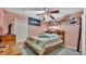 Cozy bedroom featuring a decorative ceiling fan and shelf decor at 7311 Briarbay Loop, Lakeland, FL 33810