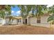 Charming home exterior with partial garage and tree view at 7311 Briarbay Loop, Lakeland, FL 33810