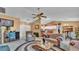 Cozy living room featuring ceiling fan, view of the breakfast bar, dining area and doors leading to outdoor space at 7311 Briarbay Loop, Lakeland, FL 33810