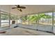 View of the screened patio with hanging plants overlooking the backyard at 7311 Briarbay Loop, Lakeland, FL 33810