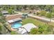 An aerial view shows a home with a screened-in porch and above-ground pool at 808 Austin Cir, Bartow, FL 33830
