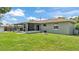 Lawn and exterior view of the home with a cozy screened-in patio, perfect for outdoor living at 808 Austin Cir, Bartow, FL 33830