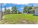 Spacious backyard with plenty of greenery, a storage building, and an outdoor carport at 808 Austin Cir, Bartow, FL 33830