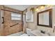 Updated bathroom featuring tiled shower with grab bars, a sink, and a vanity at 808 Austin Cir, Bartow, FL 33830