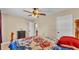 Comfortable bedroom featuring tile floors, ceiling fan and an adjacent closet at 808 Austin Cir, Bartow, FL 33830