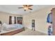 Cozy bedroom with tile flooring, ceiling fan, dresser, and large window at 808 Austin Cir, Bartow, FL 33830