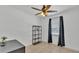 A minimalist bedroom features a ceiling fan, large window, and simple decor at 808 Austin Cir, Bartow, FL 33830