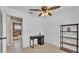 Bright bedroom with a desk, shelving and adjacent bathroom featuring tiled floors at 808 Austin Cir, Bartow, FL 33830