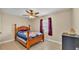 Comfortable bedroom featuring tile floors, window, and a wooden bed frame at 808 Austin Cir, Bartow, FL 33830