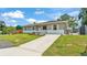 Exterior shot of a single-story home, shows the driveway, shutters and part of fenced in yard at 808 Austin Cir, Bartow, FL 33830