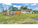 Exterior view of a home with a green metal storage shed and colorful wooden fence at 808 Austin Cir, Bartow, FL 33830