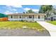 Charming single story home featuring a well-manicured lawn and a classic white and gray exterior at 808 Austin Cir, Bartow, FL 33830
