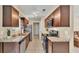 Modern kitchen with granite countertops, stainless steel appliances, and dark wood cabinets at 808 Austin Cir, Bartow, FL 33830