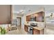 Well-lit kitchen featuring stainless steel appliances, granite countertops, and dark wood cabinetry at 808 Austin Cir, Bartow, FL 33830