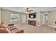 Cozy living room with tile flooring, ceiling fan, and a decorative fireplace at 808 Austin Cir, Bartow, FL 33830