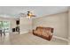 Cozy living room featuring tile flooring, ceiling fan, and neutral wall color at 808 Austin Cir, Bartow, FL 33830