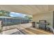 Covered patio area featuring wood decking and space for grilling and outdoor cooking at 808 Austin Cir, Bartow, FL 33830