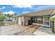 An exterior view showcasing a covered patio with grill, bar, and a convenient access door at 808 Austin Cir, Bartow, FL 33830