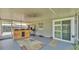 Covered patio with a wooden bar, sliding door, and view of the fenced in yard at 808 Austin Cir, Bartow, FL 33830