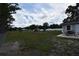 Expansive backyard featuring lush green space, mature trees, and a cozy outdoor dining area, perfect for relaxation at 5732 Sawyer Rd, Lakeland, FL 33810