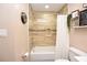 Bathroom featuring a shower over tub with a decorative tile accent, and a neutral color scheme at 5732 Sawyer Rd, Lakeland, FL 33810