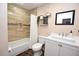 Bright bathroom featuring shower over tub with large tiles, white vanity, and modern fixtures at 5732 Sawyer Rd, Lakeland, FL 33810