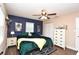 Bedroom featuring a navy accent wall, ceiling fan, and closet at 5732 Sawyer Rd, Lakeland, FL 33810