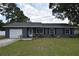 Charming single-story home featuring a brick facade, well-manicured lawn, and inviting front porch at 5732 Sawyer Rd, Lakeland, FL 33810