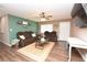 Comfortable living room featuring a ceiling fan, ample seating, and a large rug, perfect for relaxation and entertainment at 5732 Sawyer Rd, Lakeland, FL 33810