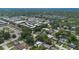 Expansive aerial view of a residential neighborhood featuring tree-lined streets and a variety of single-Gathering homes and apartments at 3813 Surrey Dr, Orlando, FL 32812