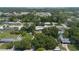 Aerial view showcasing houses surrounded by mature trees in a quiet residential area at 3813 Surrey Dr, Orlando, FL 32812