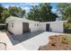 White exterior with black doors, concrete pad, mulch beds, pool and privacy fence at 3813 Surrey Dr, Orlando, FL 32812