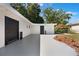 White exterior with black doors, concrete pad, mulch beds and privacy fence at 3813 Surrey Dr, Orlando, FL 32812