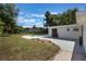 Backyard with a private pool, grassy yard and a modern building at 3813 Surrey Dr, Orlando, FL 32812