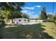 Well-manicured lawn with pool and patio, white exterior, and privacy fence at 3813 Surrey Dr, Orlando, FL 32812