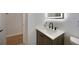 Modern bathroom features a vessel sink with black hardware and a lighted mirror at 3813 Surrey Dr, Orlando, FL 32812