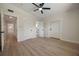 Inviting bedroom with wood floors, neutral walls, and a fan and light fixture at 3813 Surrey Dr, Orlando, FL 32812