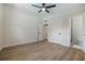 Bright bedroom featuring a ceiling fan, wood-look floors and ensuite bathroom access at 3813 Surrey Dr, Orlando, FL 32812