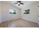 Bright room featuring wood-look floors, white trim, and two windows at 3813 Surrey Dr, Orlando, FL 32812