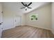 Inviting bedroom with wood floors, neutral walls, and a fan and light fixture at 3813 Surrey Dr, Orlando, FL 32812