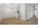 Open-concept dining room showcasing wood floors, bright lighting, and modern finishes at 3813 Surrey Dr, Orlando, FL 32812